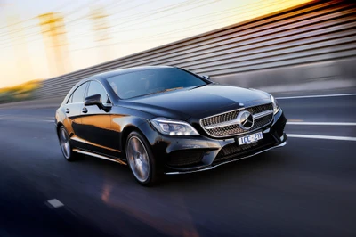 Sleek Black Mercedes-Benz CLS Class in Motion on a Dynamic Roadway.