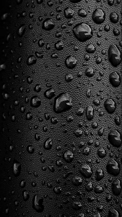 Textured Black Surface with Crisp Water Droplets