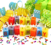 Colorful birthday candles spell out "HAPPY BIRTHDAY" surrounded by confetti and gift boxes.