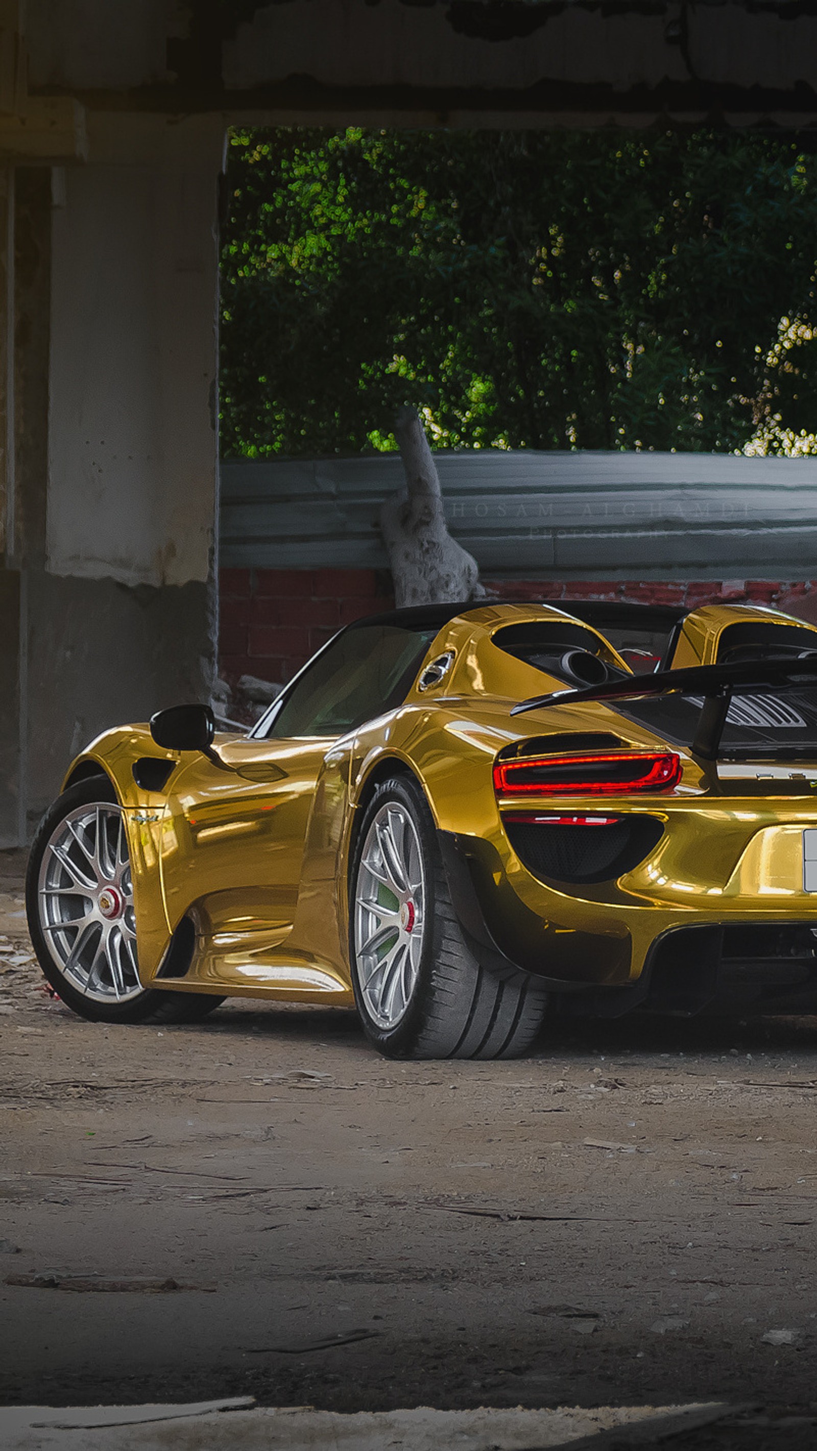 Arafed yellow sports car parked in a parking lot with a smoke coming out of the back (car, gold, porsche, spyder)