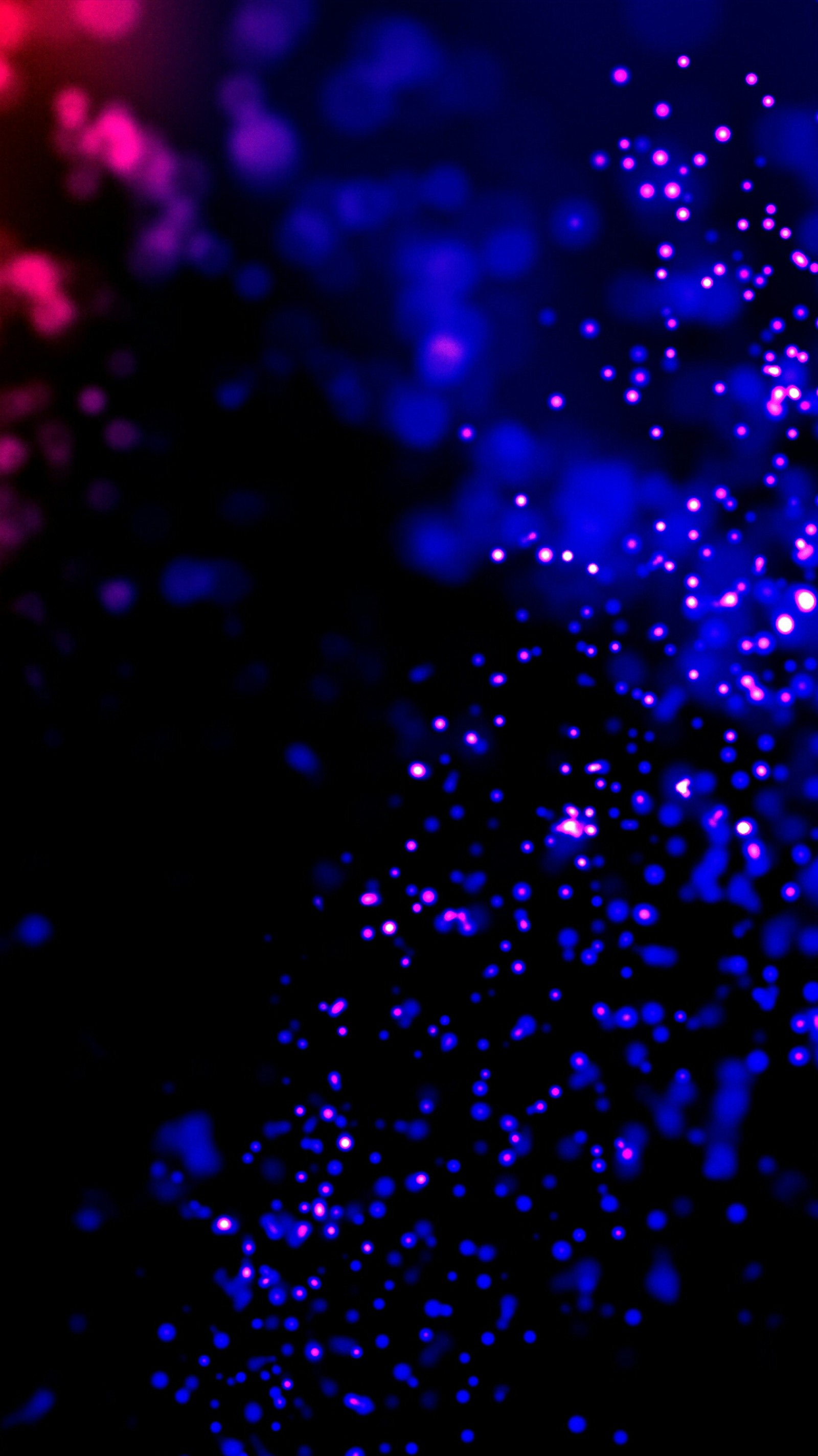 A close up of a cell phone with a blurry background (black, blue, material, purple, red)