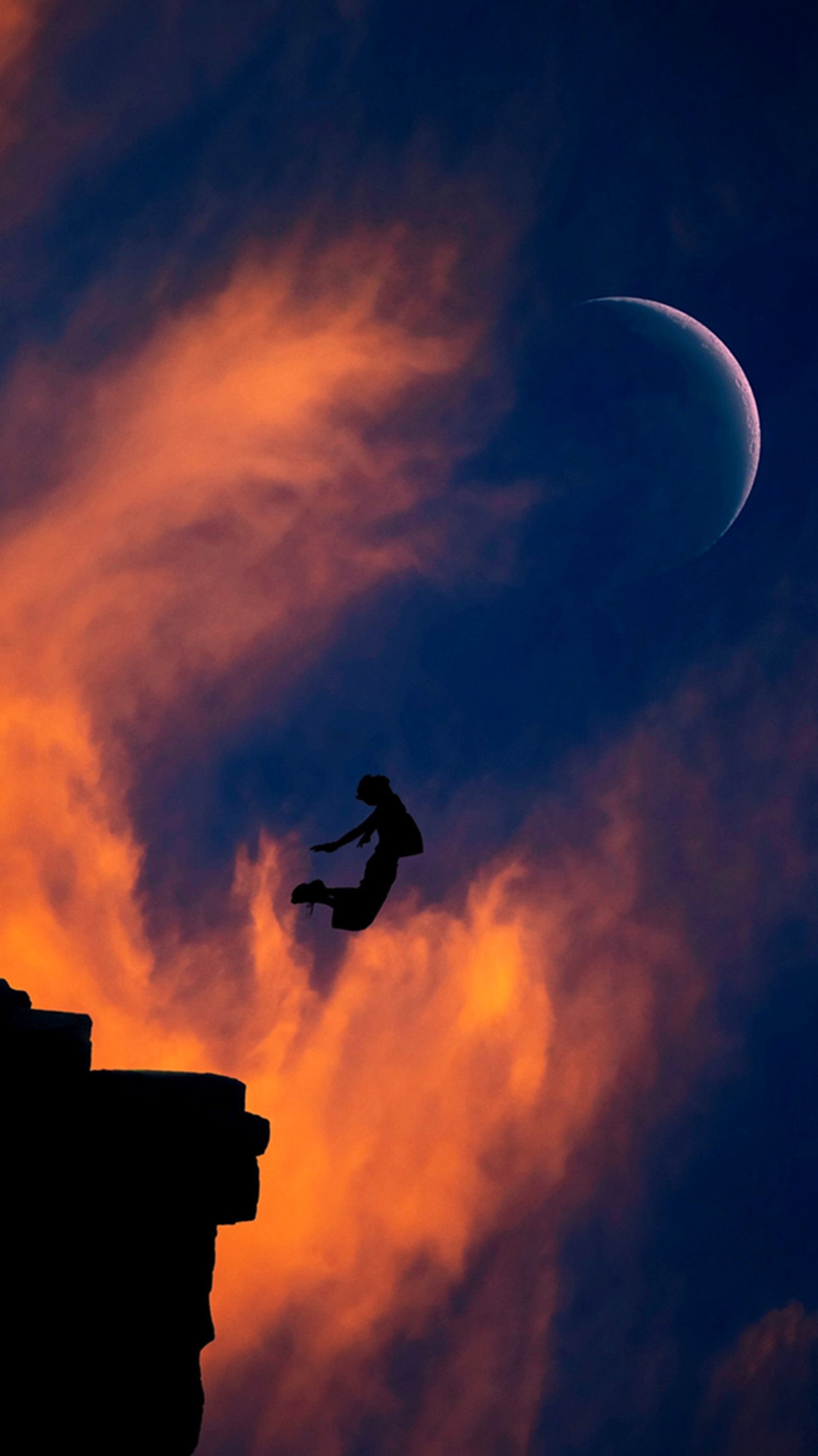 Arafed man jumping off a cliff into the sky (moon, moonlight, night)