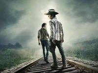 Rick Grimes et Carl Grimes sur une voie de train désolée dans le final de saison de "The Walking Dead