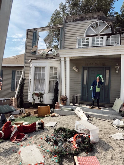 Damaged Cottage with Disarrayed Holiday Decor and Open Roof