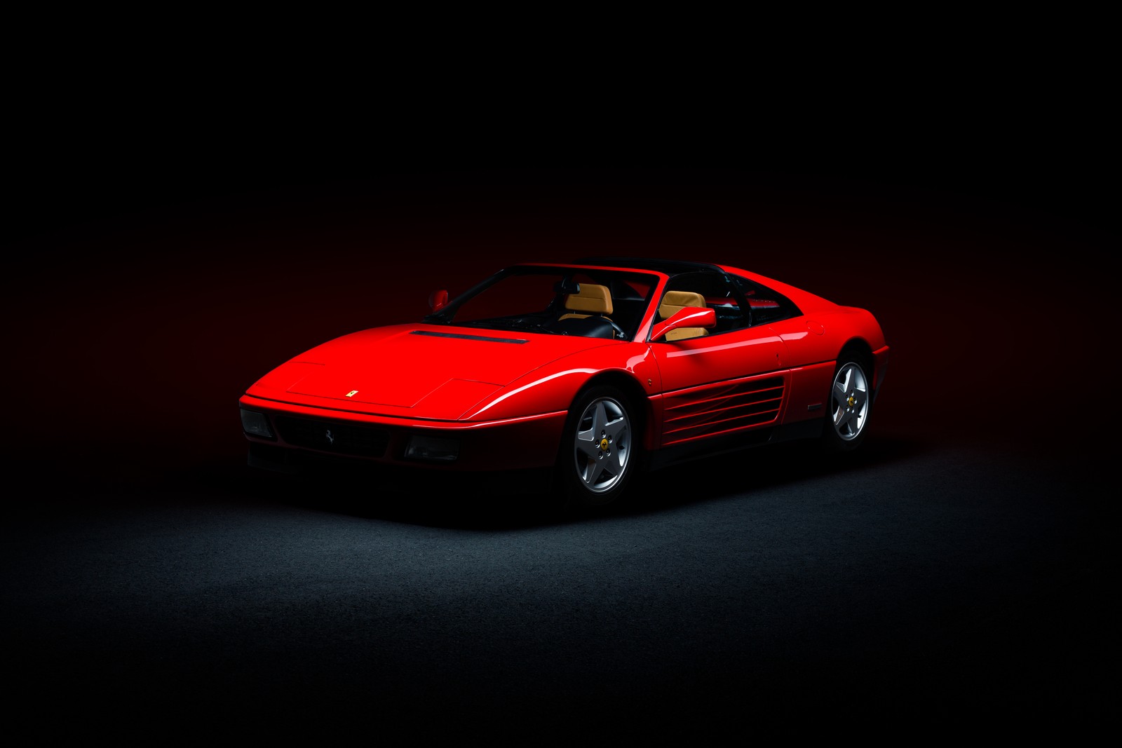 A close up of a red sports car in a dark room (ferrari 348, classic cars, sports car, 5k, cars)