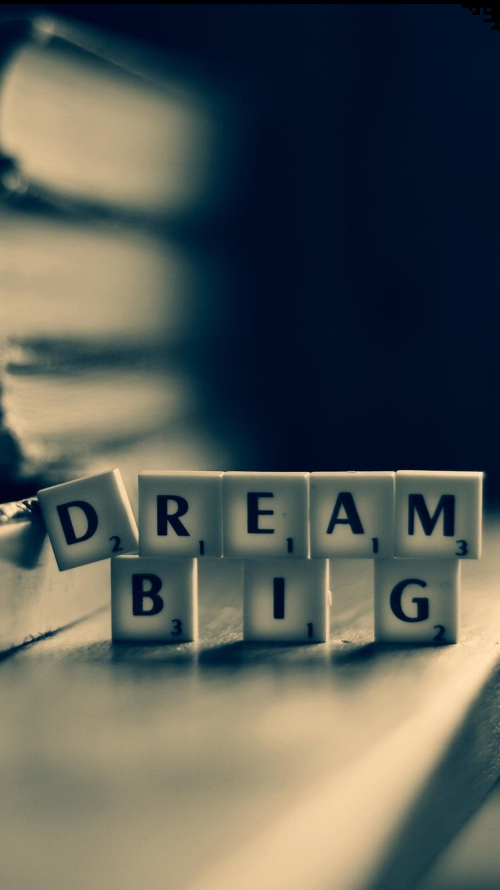 Arafed image of a book with the words dream big spelled on it (dream, scrabble, tiles)