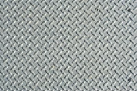 Brushed metal diamond plate texture with a raised pattern.