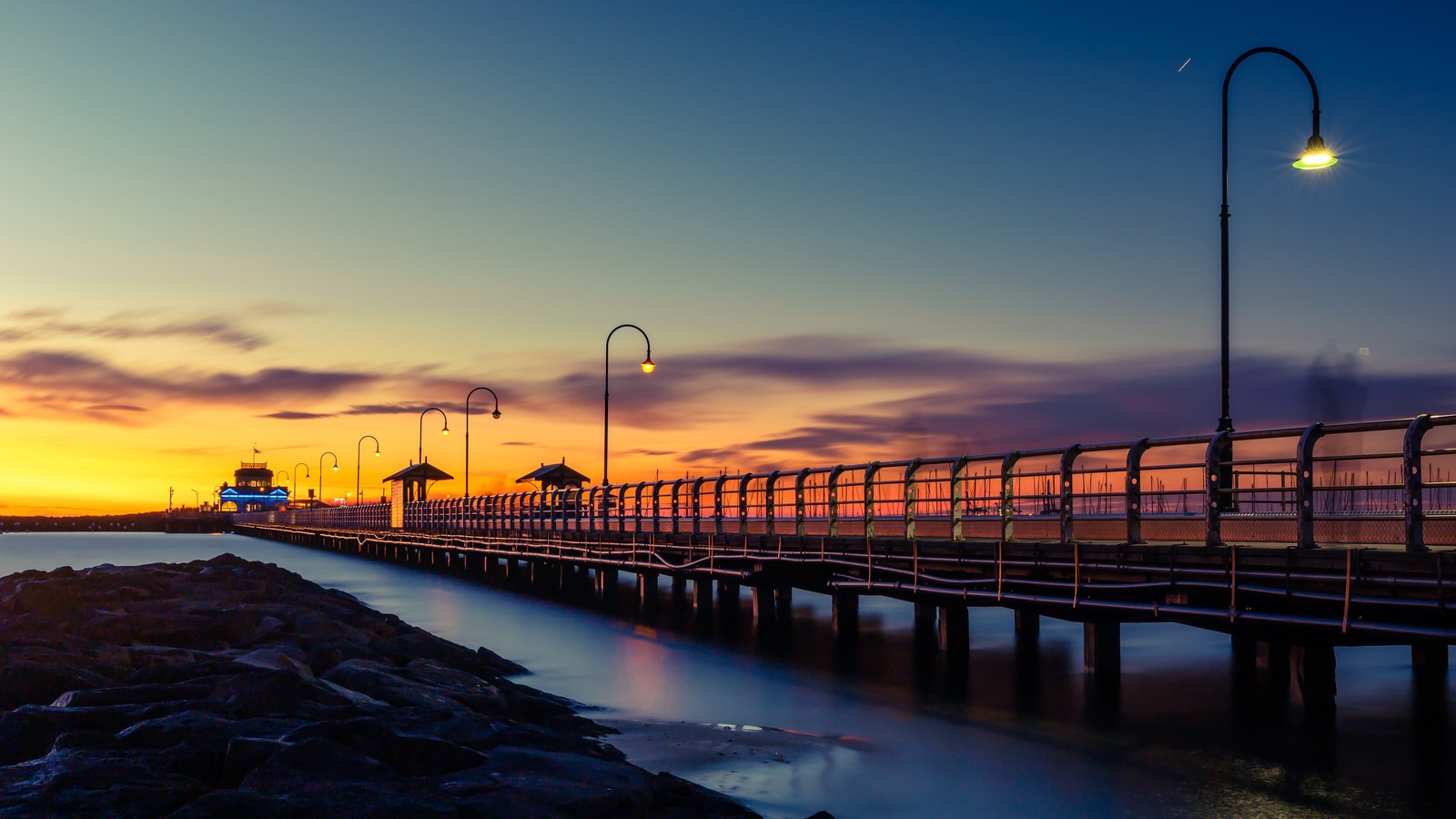 A view of a pier with a lighthouse at sunset (sunset, sea, bridge, landscape, scenery)