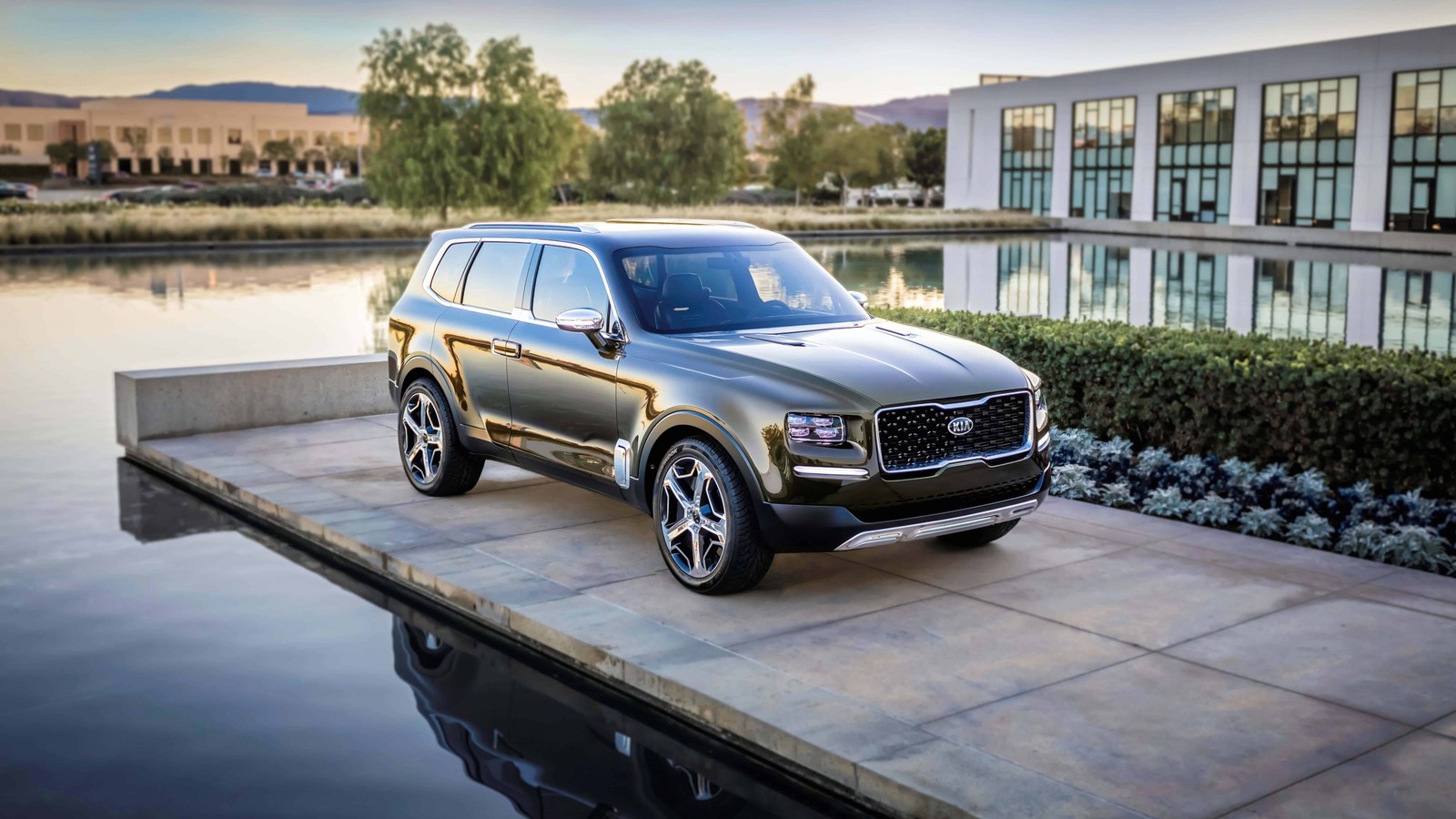 A silver 2020 ford expedition is parked on a dock near a lake (kia motors, car, automotive tire, rim, tire)