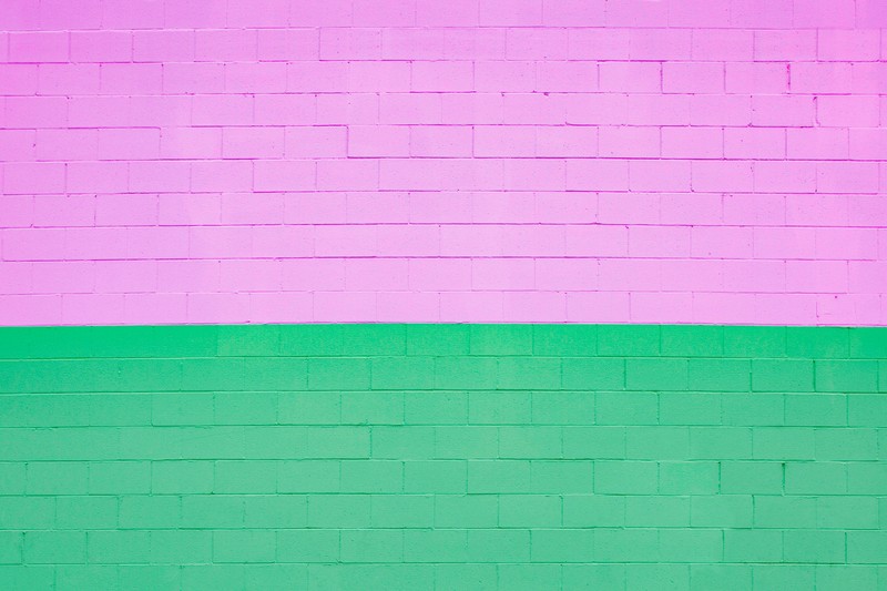 Arafed wall with a fire hydrant in front of a pink and green wall (texture, brick, pink, green, magenta)