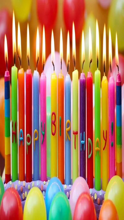 Colorful birthday cake candles with a cheerful "Happy Birthday!" greeting, set against a festive background of balloons.