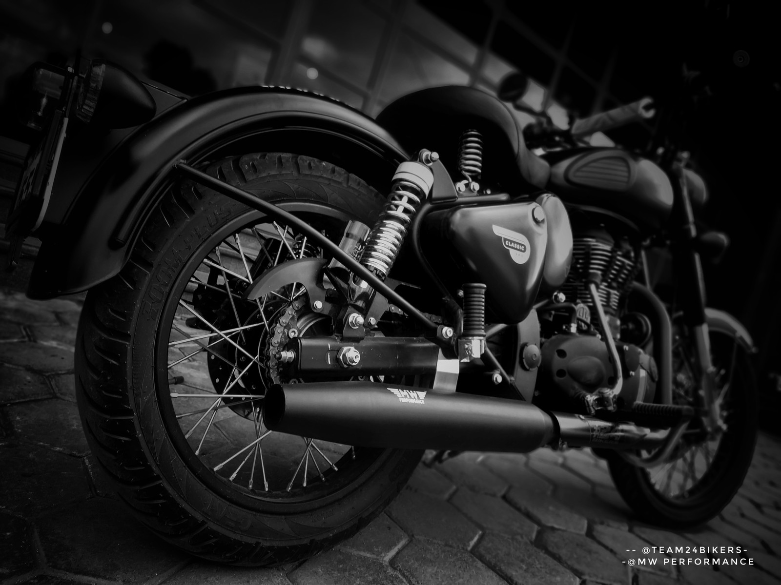 A close up of a motorcycle parked on a brick road (bike, mw exhaust royal enfield, royal enfield mujju24)