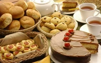 Delicious Assortment of Baked Goods with Chocolate Cake and Freshly Brewed Tea