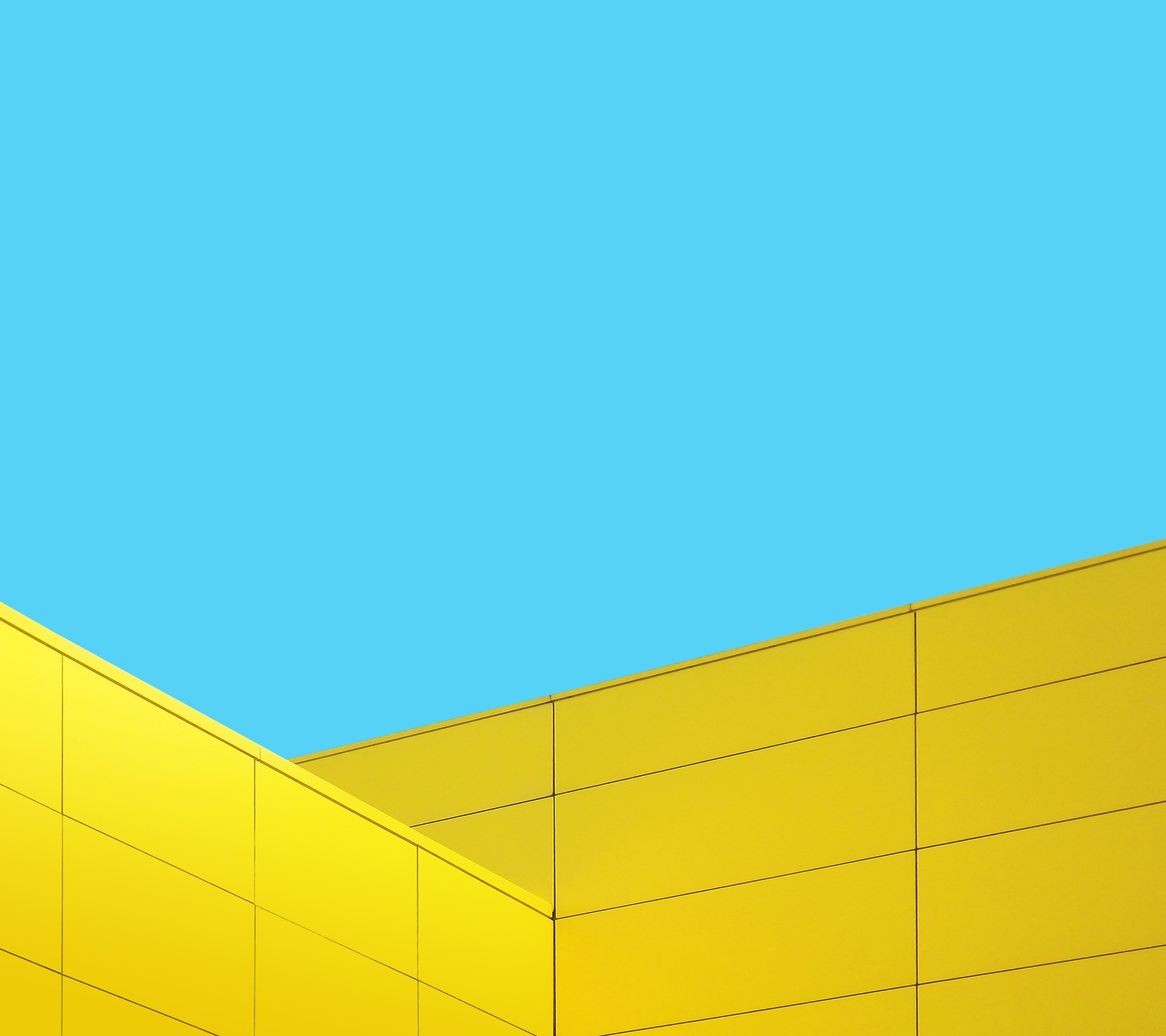 Yellow building with a blue sky in the background (design, g4, lg, material)