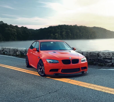 BMW E90 M3 Sedan rouge modifié sur route pittoresque