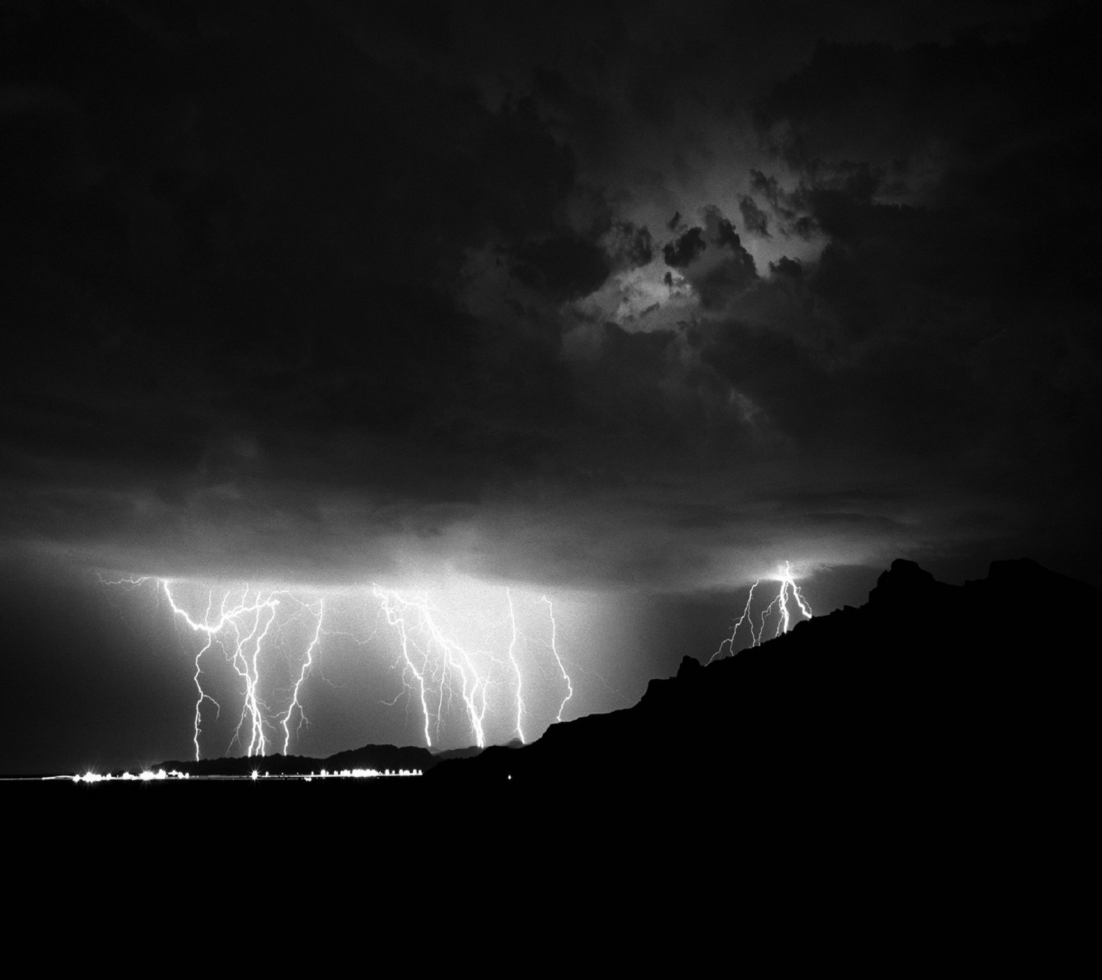 Arafed image of a lightning storm in the sky over a mountain (rain, stormy)