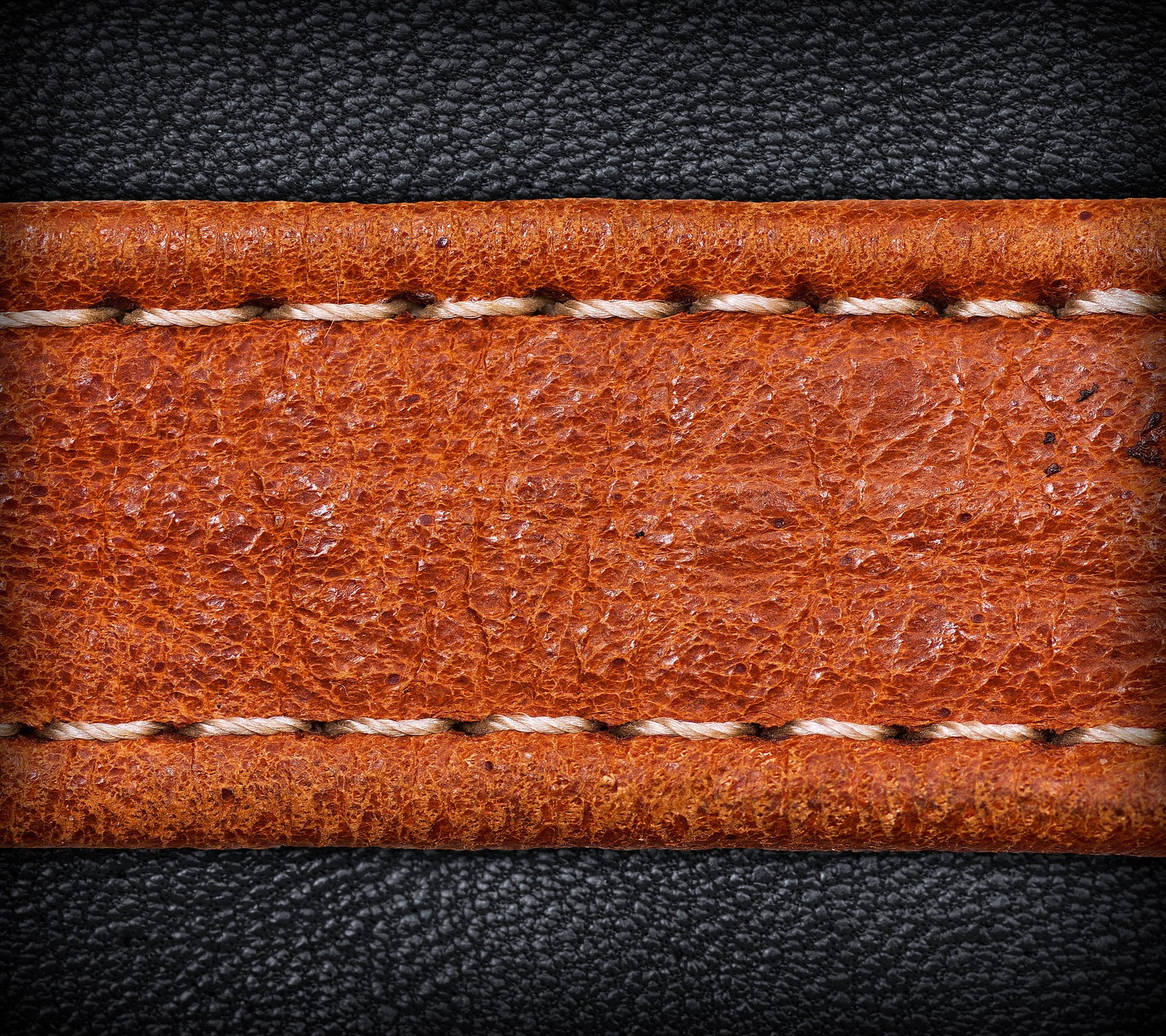 A close up of a leather background with a stitching strip (black, design, leather, texture)