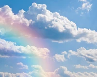 A vibrant rainbow arches through a serene sky filled with fluffy cumulus clouds, bathed in warm sunlight, creating a tranquil daytime skyscape.