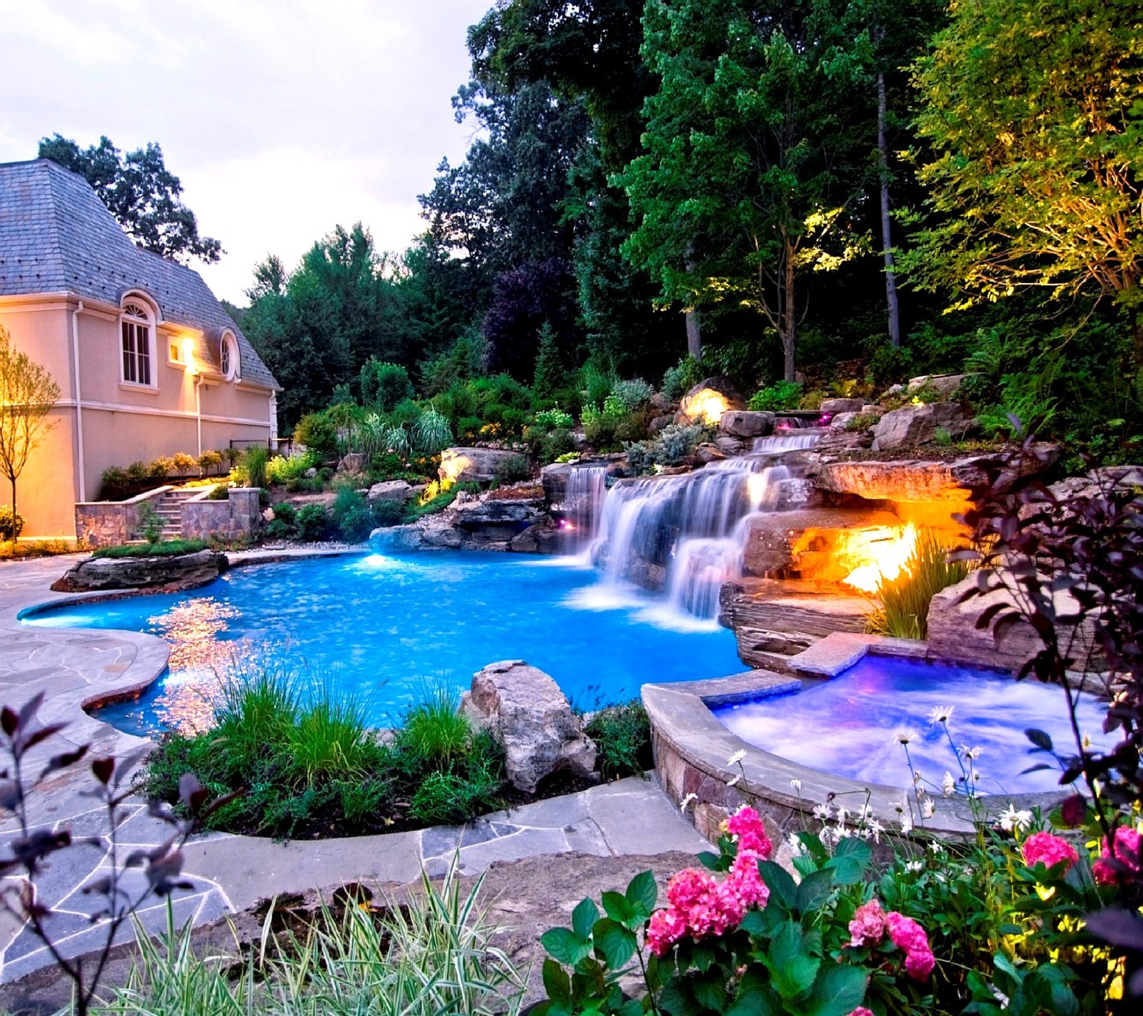 A close up of a pool with a waterfall and a waterfall (nice)