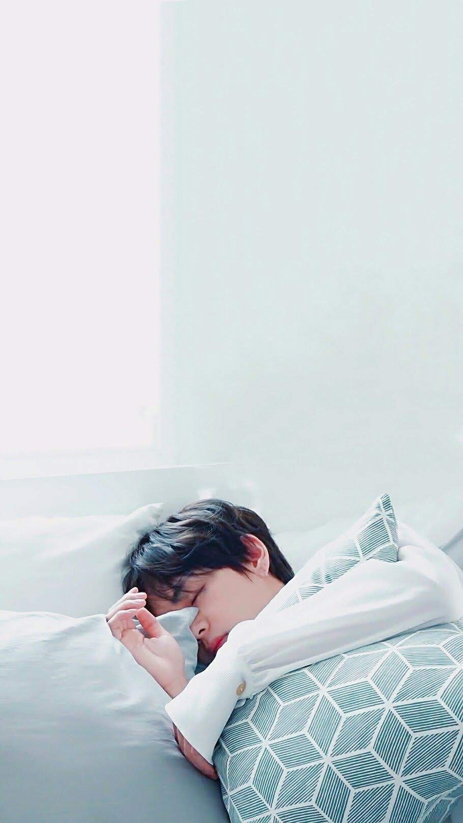 There is a woman laying in bed with a pillow and a blanket (bts, bts v, tae, taehyung)