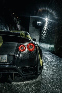 Nissan GT-R in a dimly lit alley, showcasing its sleek design and wet asphalt reflecting its dynamic colors.