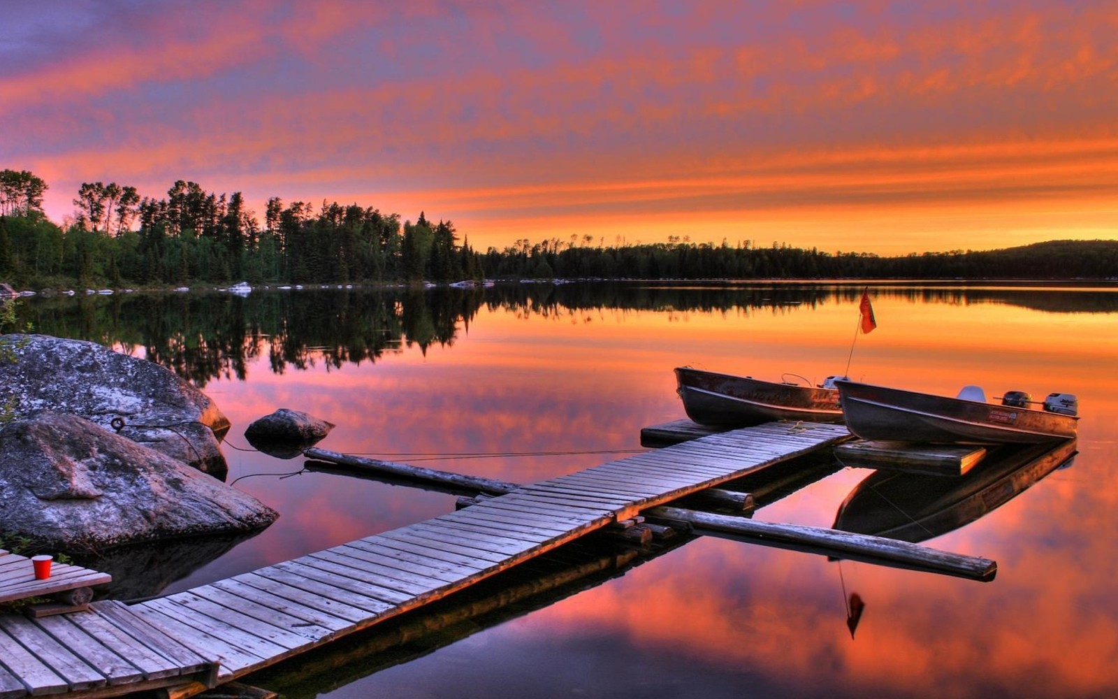 Boats docked on a dock at a lake at sunset (nature, sunset, reflection, water, morning)