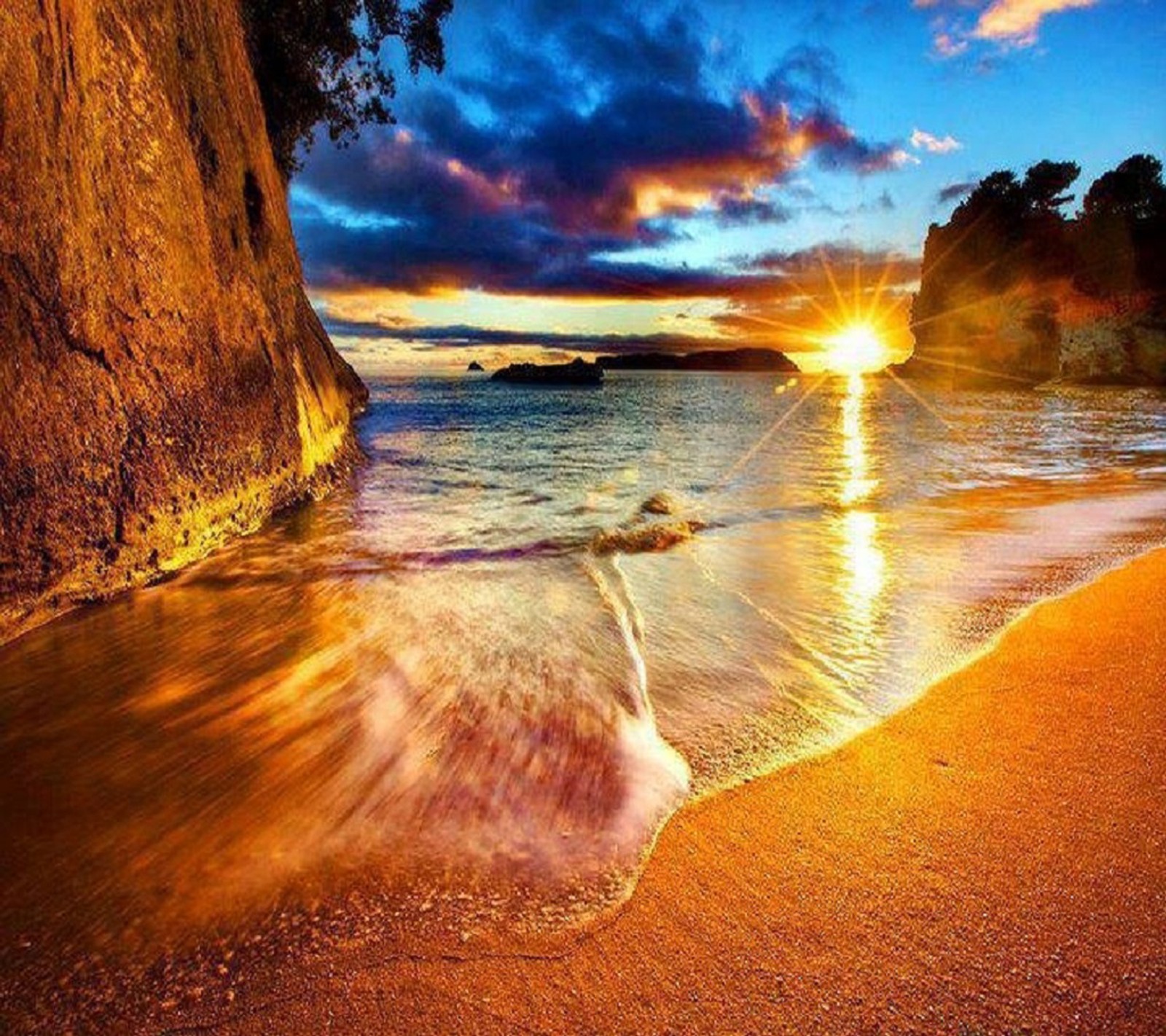 Un coucher de soleil sur la plage avec des vagues se brisant devant un rocher (beau, coucher de soleil)