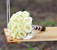 Elegant White Rose Bouquet on a Wooden Swing