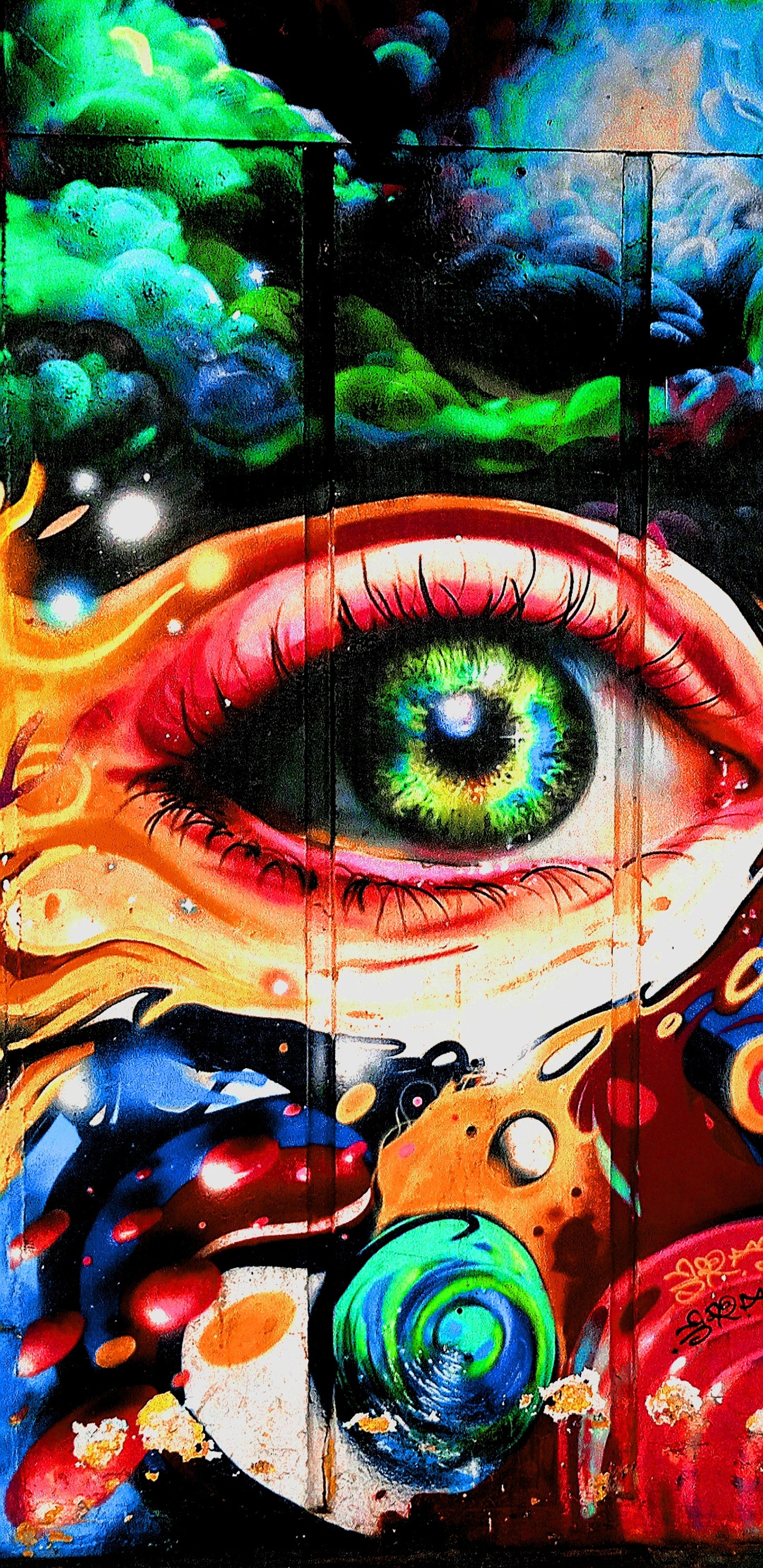 Graffiti of a woman's eye with a colorful background (blue, eye, graffiti, green, orange)