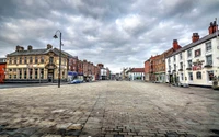 Quiet Town Square with Historic Buildings Under a Cloudy Sky