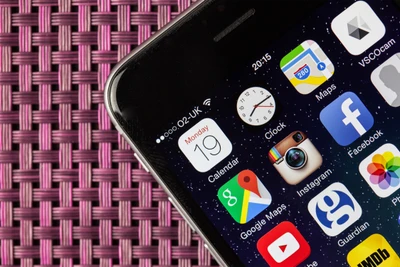 Apple Smartphone Displaying Apps on a Colorful Background