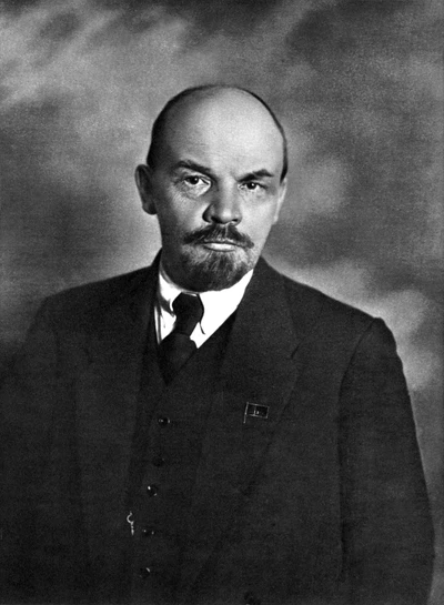 Vladimir Lenin in formal wear with a moustache and beard, captured in a monochrome portrait.