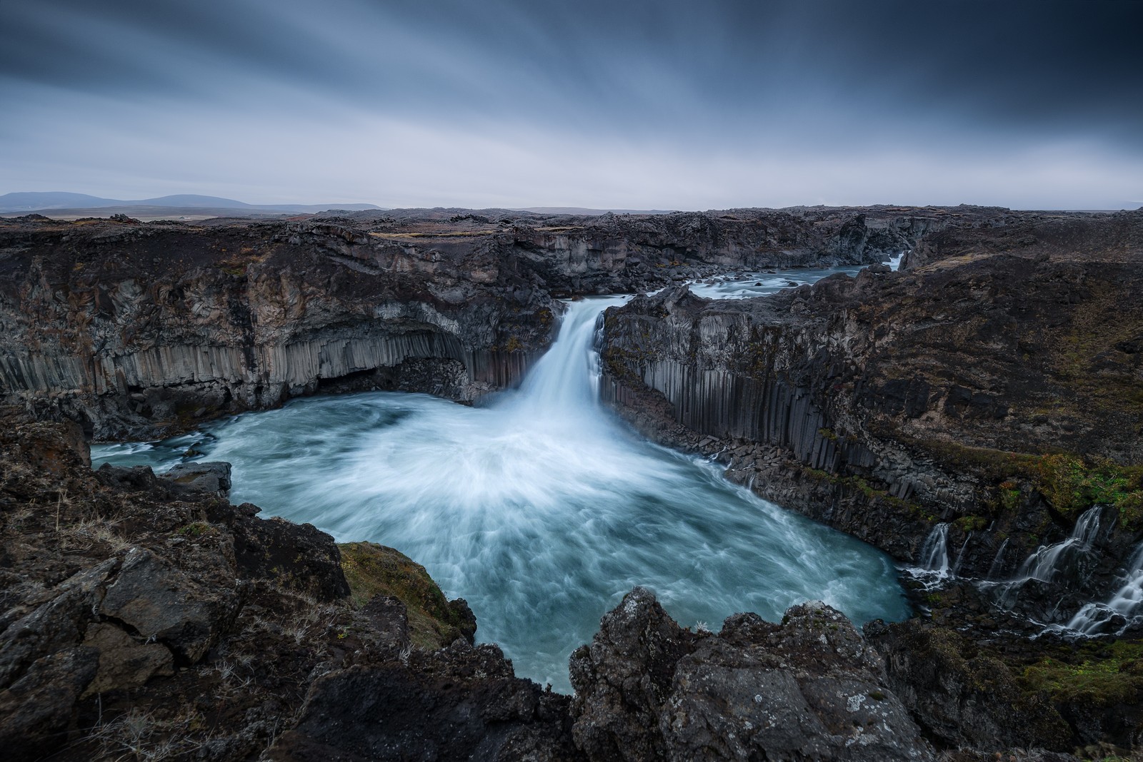 A waterfall flowing through a rocky gorge in iceland (aldeyjarfoss waterfall, iceland, skjalfandafljot river, rocks, 5k)