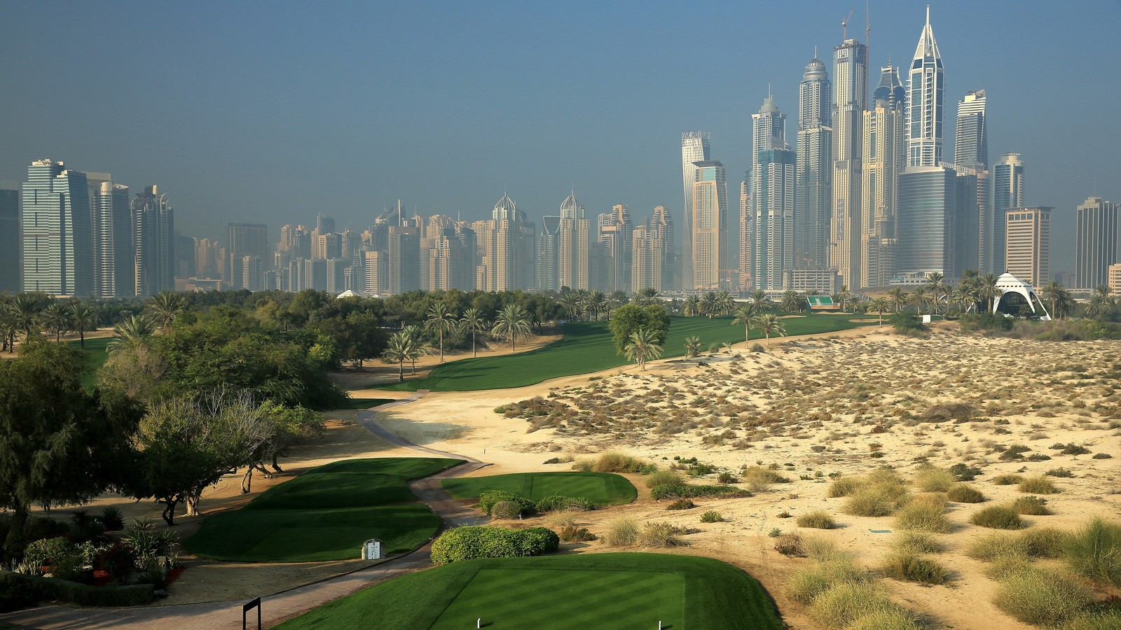 Une vue d'un parcours de golf avec une ville en arrière-plan (terrain de golf, golf, paysage urbain, zone urbaine, ville)