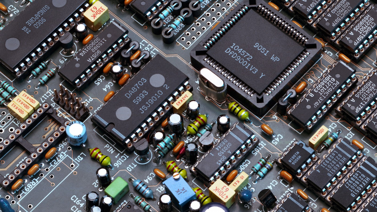 A close up of a computer mother board with many electronic components (electronic engineering, electronic component, circuit component, electrical network, electronic device)