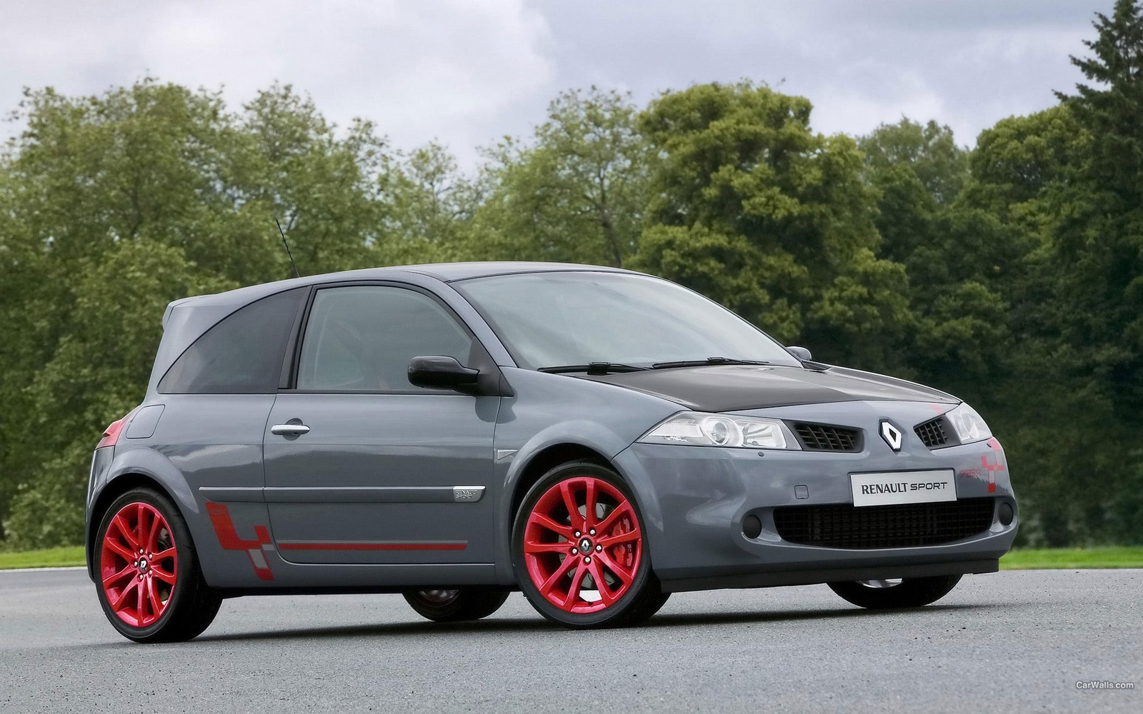 A close up of a car on a road with trees in the background (renault, car, hatchback, alloy wheel, rim)