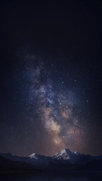 Montanhas iluminadas por estrelas: Um céu noturno sereno sobre picos majestosos