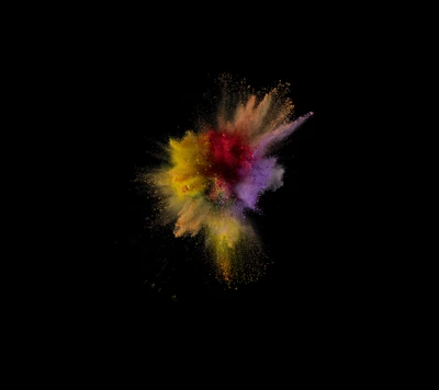 Colorful explosion of vibrant dust against a black background.