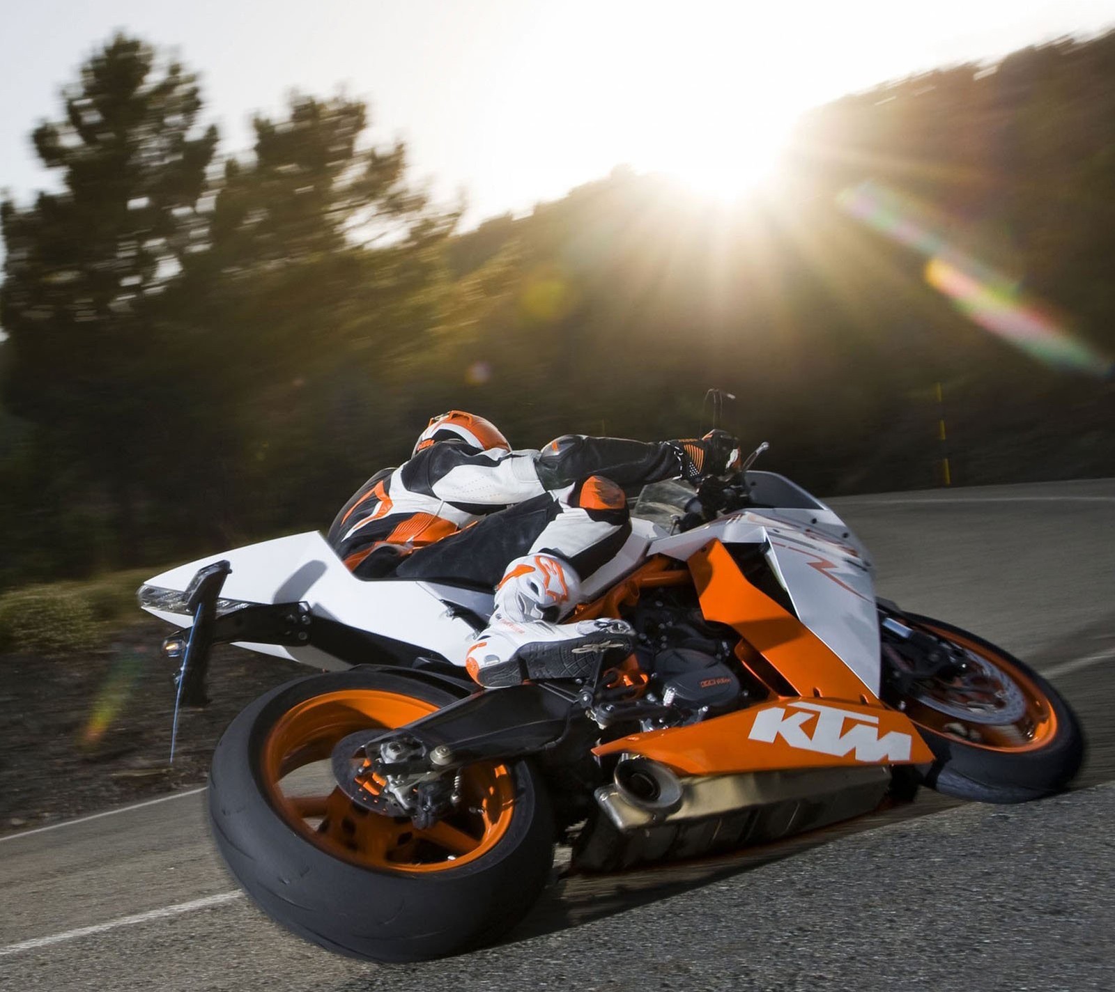 Motorcycle on the road with the sun shining behind it (awesome, cool)