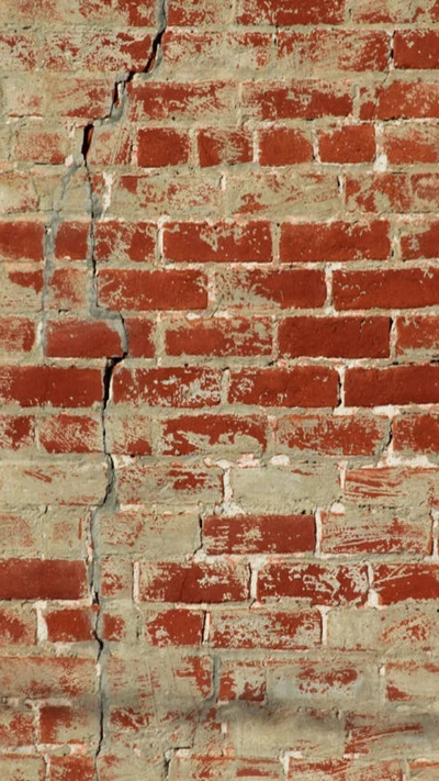 Texture de mur en briques rouges fissurées