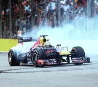 Vettel célèbre sa victoire avec de la fumée de pneus lors de la course F1 de Red Bull