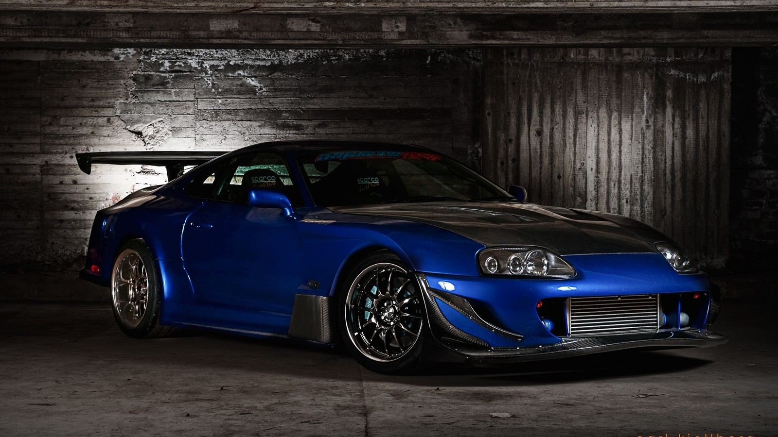 Arafed blue sports car parked in a garage with a brick wall (sports car, car, toyota, car tuning, hood)