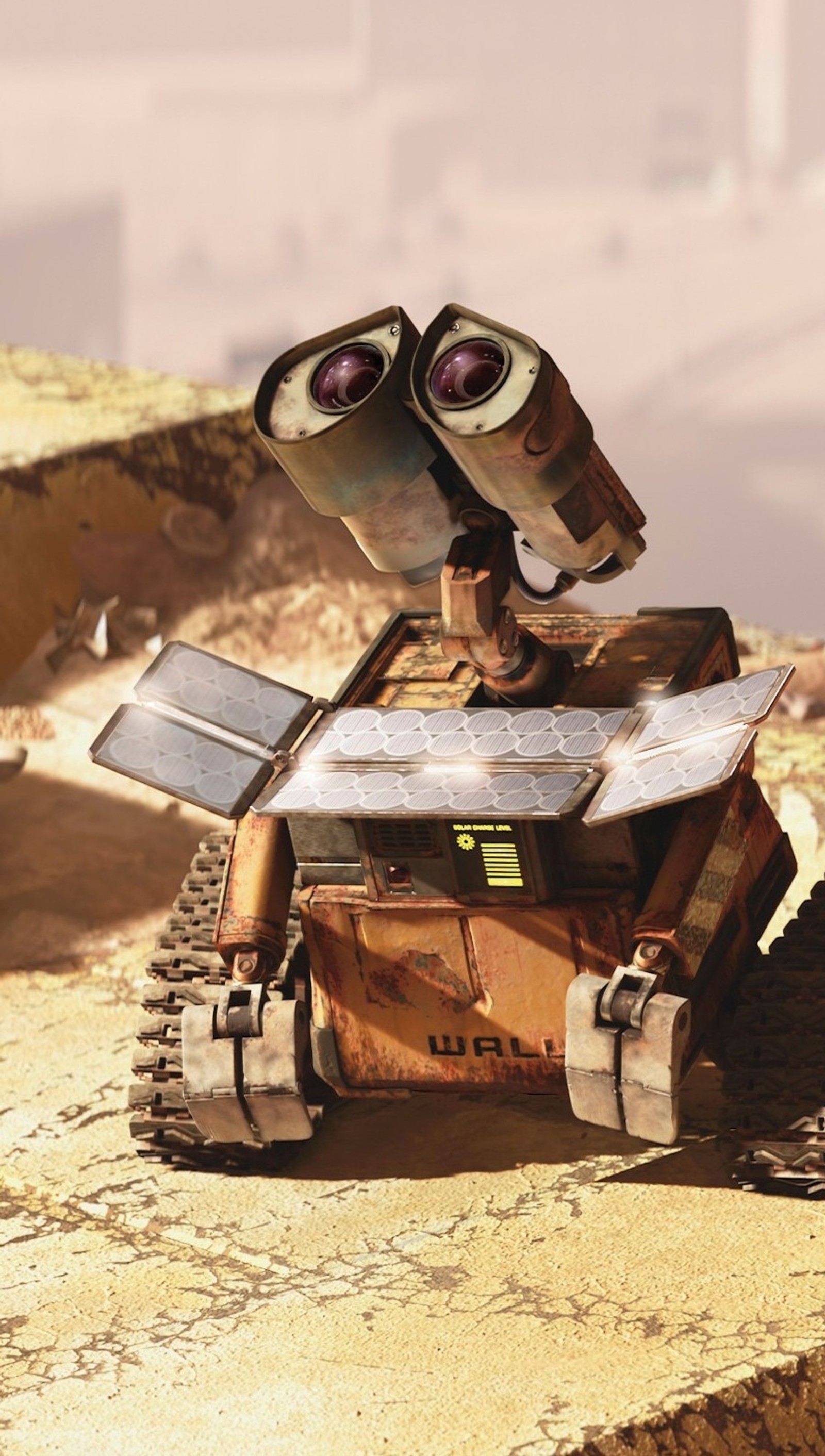 There is a robot that is sitting on a rock (looking, up, wall e)