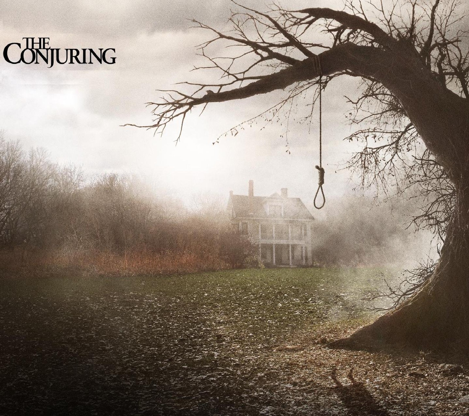 A close up of a tree with a hanging rope in front of a house (haunted, hollywood, horror, landscape, nature)