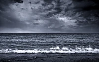 Monochrome Ocean Waves Against a Dramatic Sky