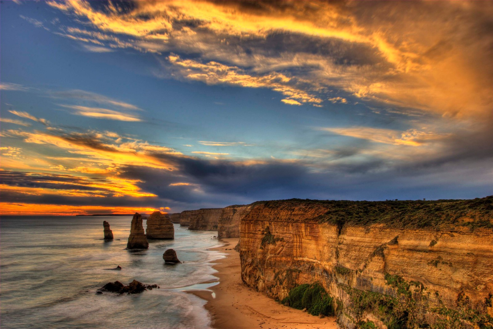 Sunset over the twelve apostless, great ocean road, victoria, australia (cliff, cloud, sea, coast, horizon)