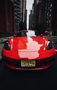 Striking red sports car parked against a city skyline, showcasing its sleek design and vibrant color.