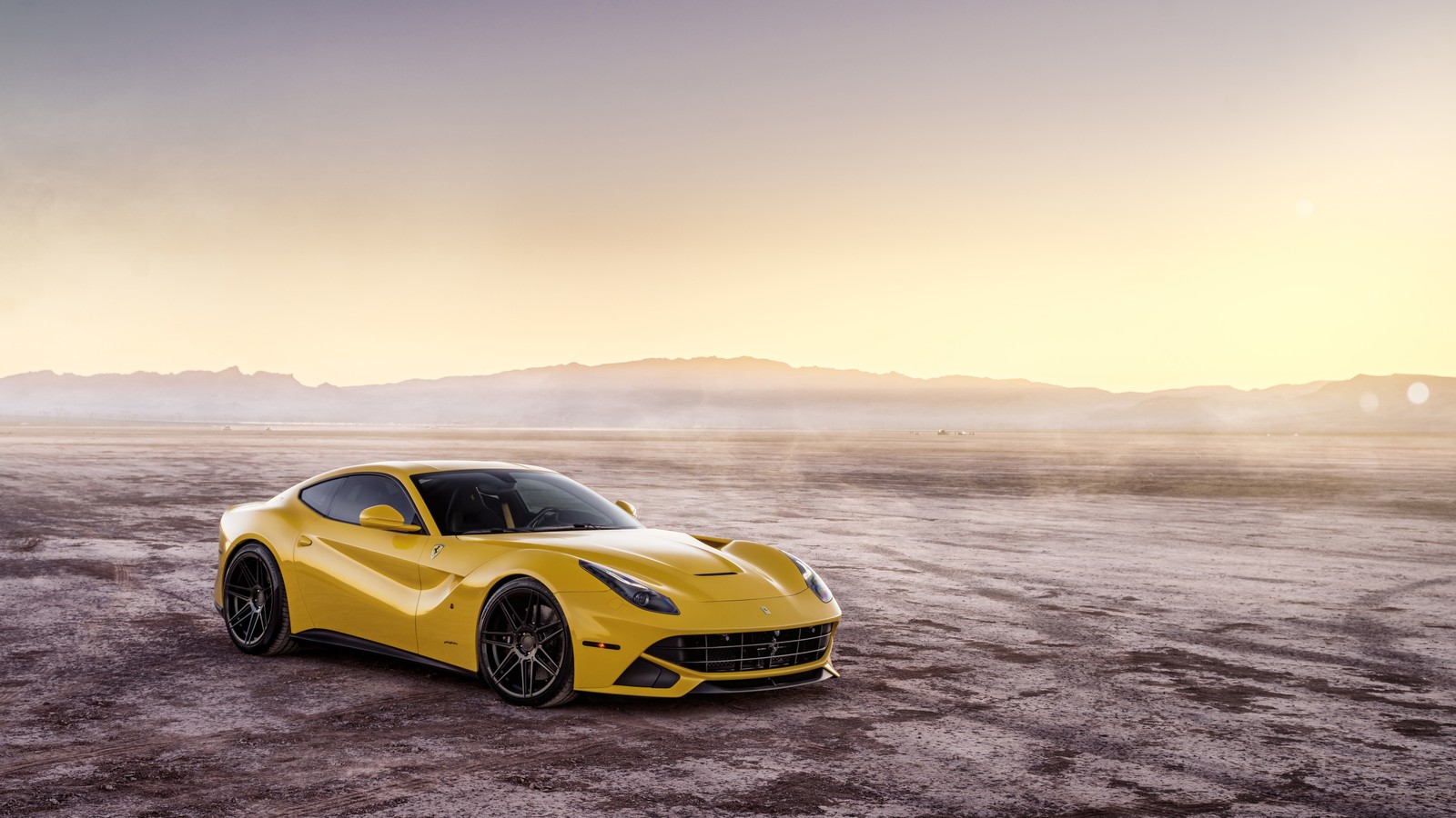 A yellow ferrari sports car parked in a desert area (car, sports car, ferrari, supercar, yellow)