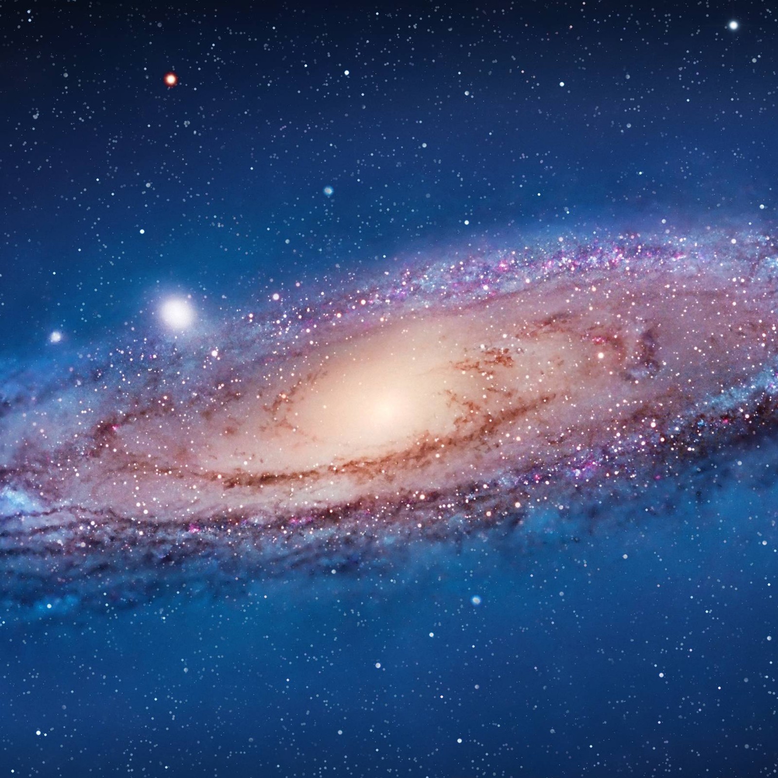 A close up of a spiral galaxy with a bright blue center (apple, lion, mac osx)