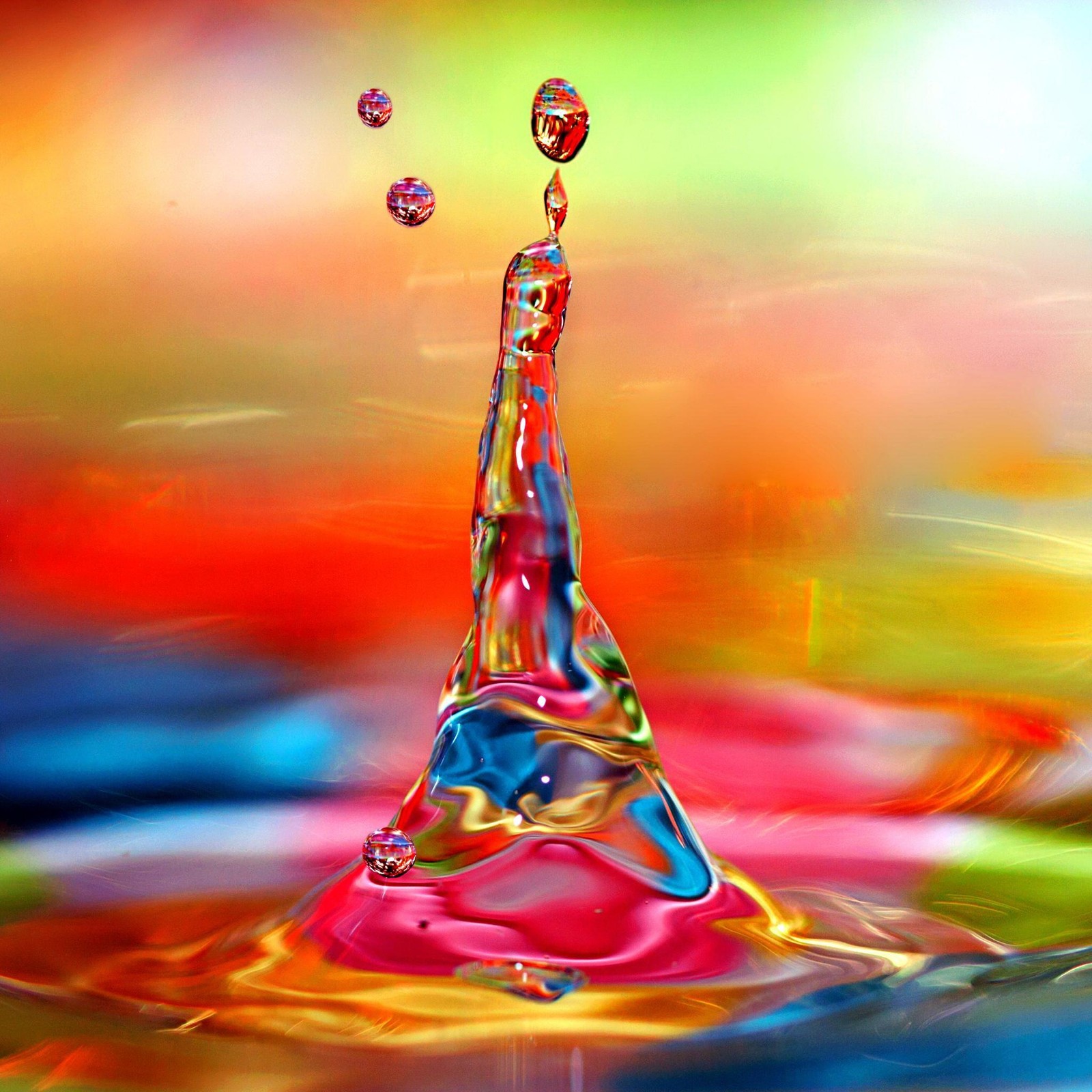 A close up of a water drop with a rainbow background (abstract, beautiful, color, colorful, colour)